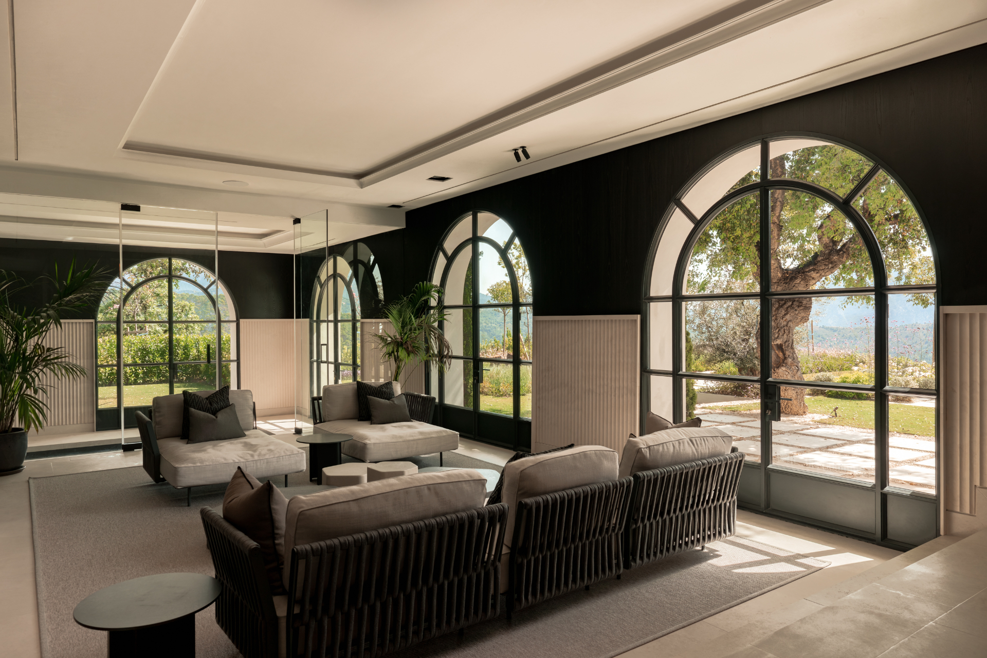Arched garden-room with mature olive tree beyond.
