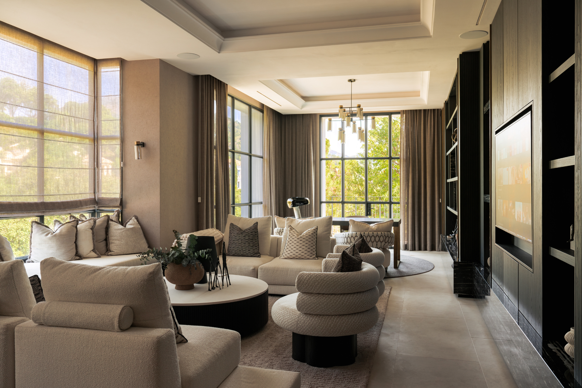 Media lounge in soft neutral tones.