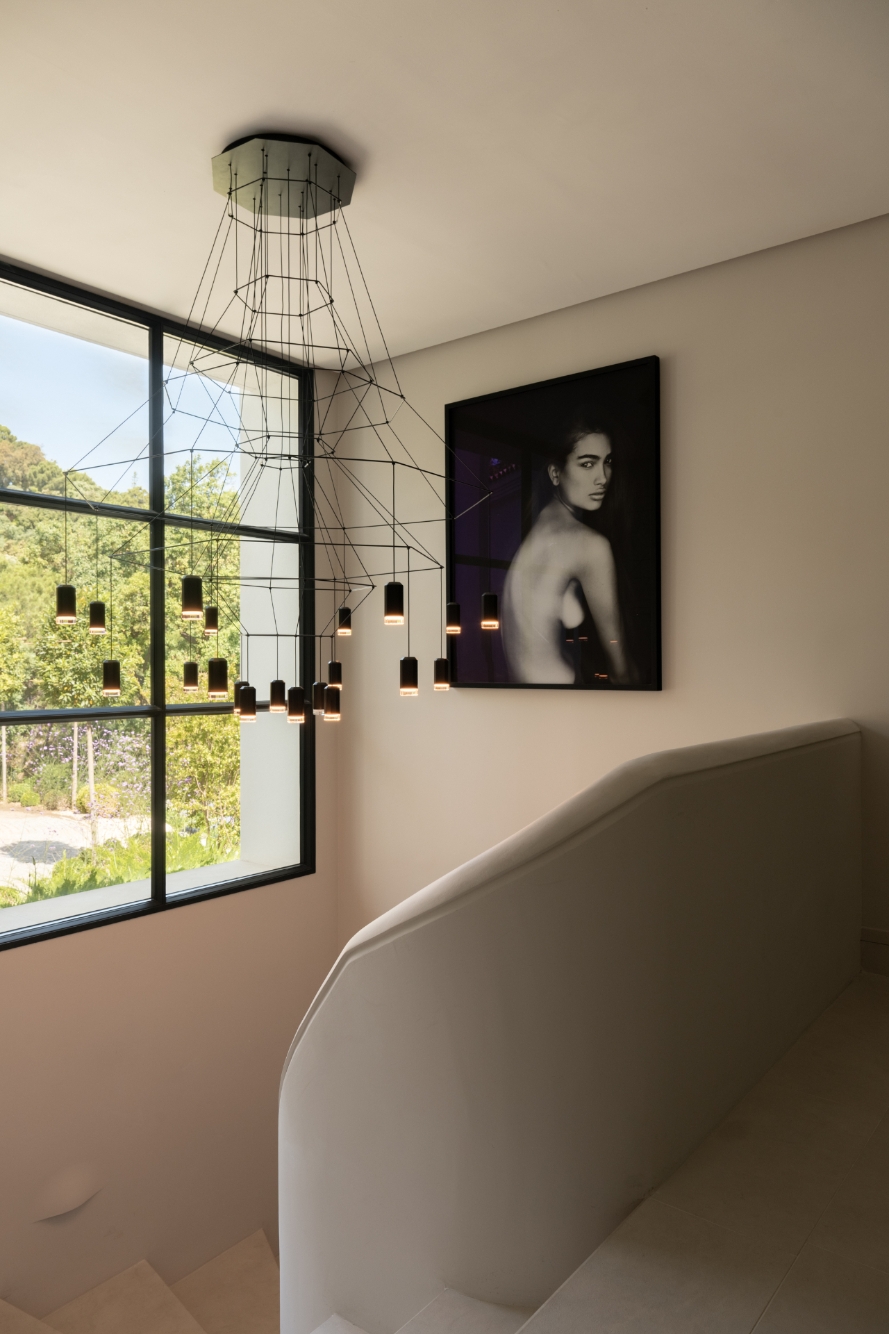 A sculptural stair hall at Casa Servetta illuminated by natural light.